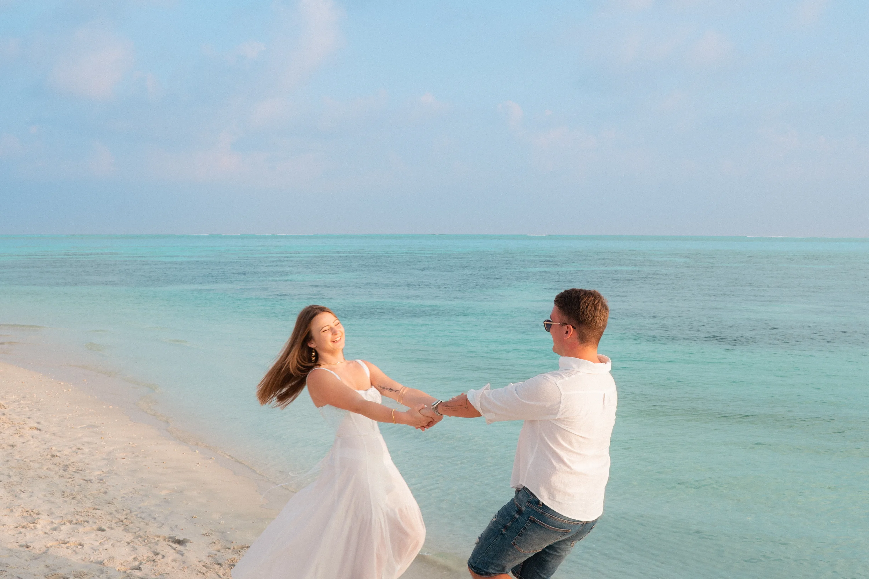 A guided couples shoot on the beach at dusk